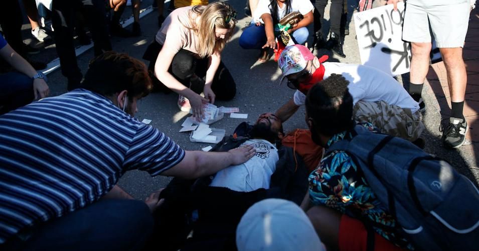  People gather around a man after he was presumably hit by a car on the 110 north freeway during a Black Lives Matter protest in downtown on Wednesday, May 27, 2020 in Los Angeles.(Photo: Dania Maxwell / Los Angeles Times via Getty Images)