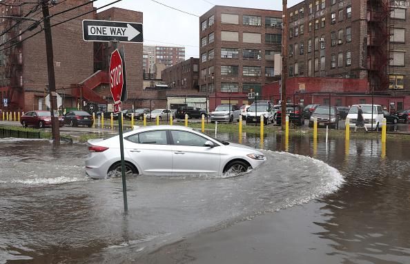 A car drives through a flooded intersecton as Tropical Storm Fay passes through the New York City area on July10, 2020 in Hoboken, New Jersey. (Photo: Gary Hershorn/Getty Images)