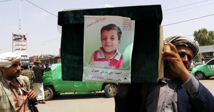 A man carries the coffin of a child at the funeral procession for those killed in an airstrike on a bus carried out last week by a warplane of the Saudi Arabia-led coalition on August 13, 2018 in Saada, Yemen.