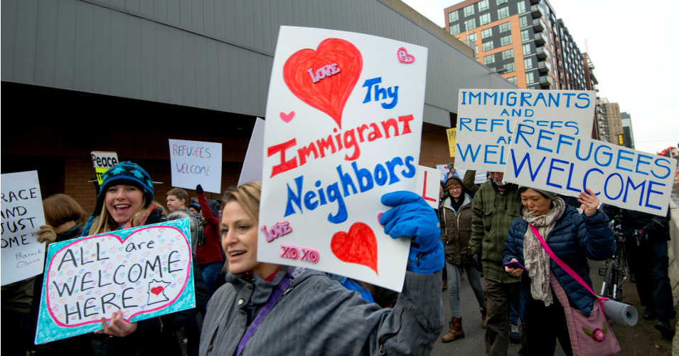 Protesters hold up signs during a "Caravan of Love" walk in support of immigrants and refugees in Minneapolis, Minn., on February 11.