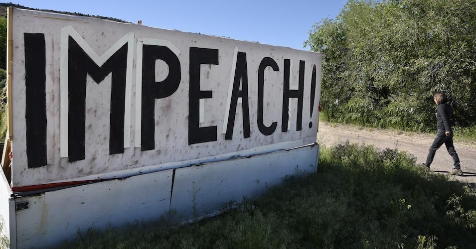 A large handmade sign erected along a highway in Velarde, New Mexico, urges that President Donald Trump be impeached. 