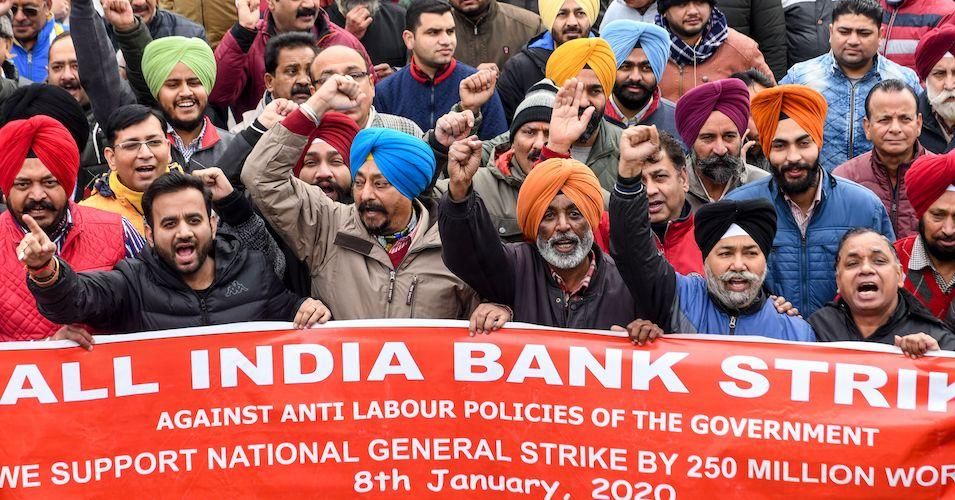 Bank employees shout slogans during a nationwide general strike called by trade unions aligned with opposition parties to protest against the Indian government's economic policies in Amritsar on January 8, 2020.
