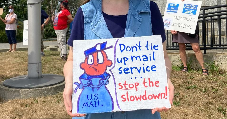 A protester holds a sign outside a post office in Bar Harbor, Maine on August 25, 2020. (Photo: Indivisible MDI)