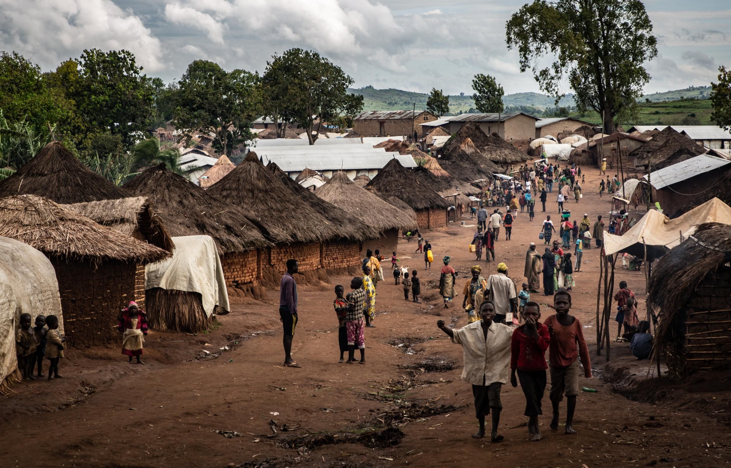 Displaced people walking in the main alley of Tsuya camp in the parish of Drodro, northeastern Democratic Republic of the Congo. (Photo: NRC/Tom Peyre-Costa)
