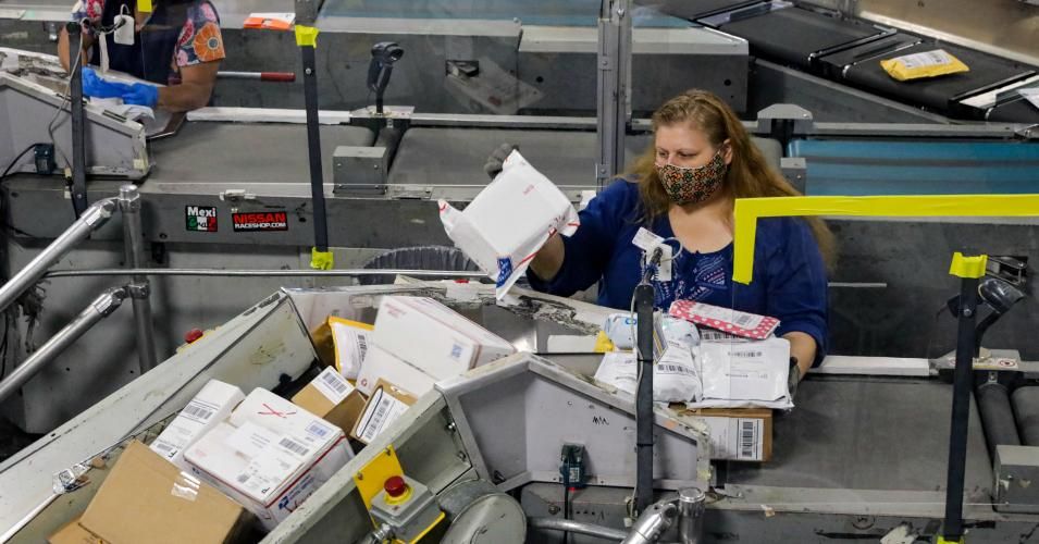Mail clerks sort packages at a USPS Processing and Distribution Center on Thursday, May 14, 2020 in City of Industry, California. (Photo: Irfan Khan/Los Angeles Times via Getty Images)