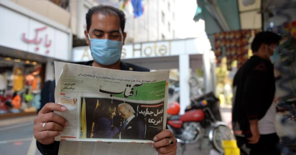An Iranian citizen reads a newspaper in Tehran following U.S. President-elect Joe Biden's victory in the 2020 presidential election, which many hope will lead to a restoration of the 2015 nuclear deal and a lifting of economic sanctions. (Photo: Fatemeh Bahrami/Anadolu Agency via Getty Images)