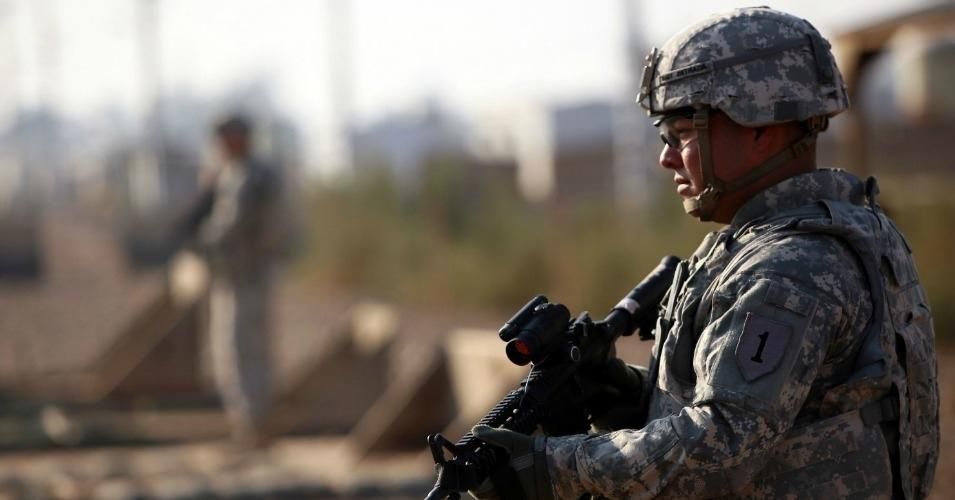 An American soldier stands guard at the Taji base complex, which hosts Iraqi and U.S. troops.
