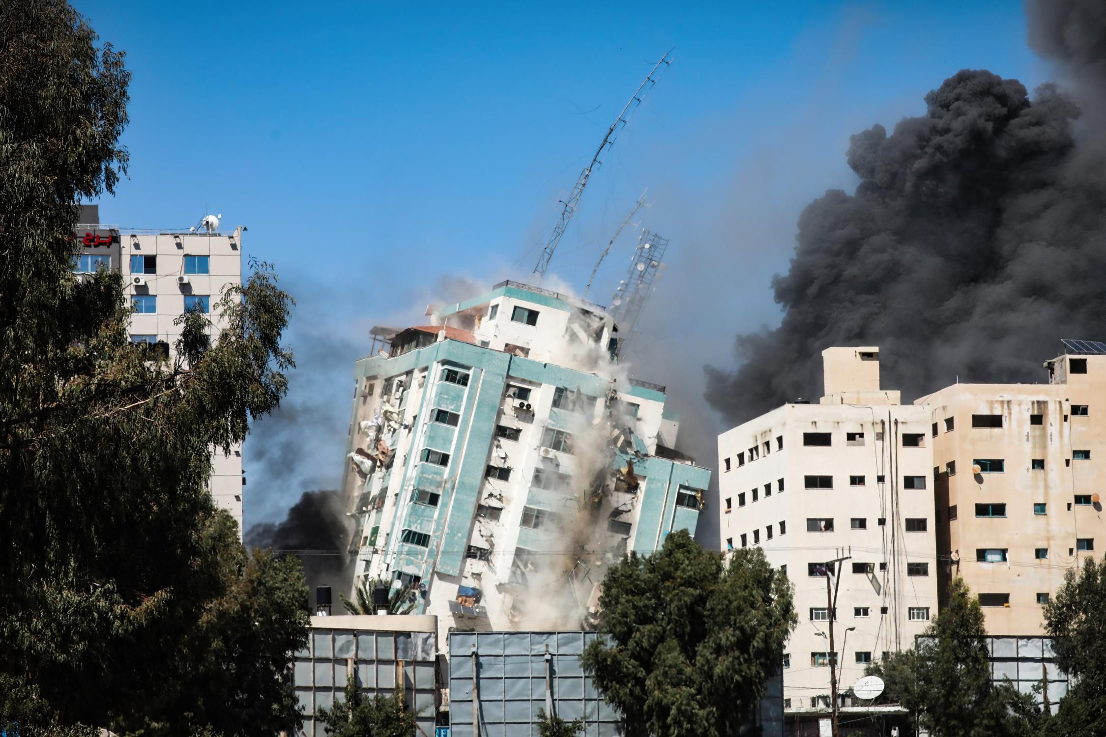 An Israeli airstrike destroys a high-rise building in Gaza City that housed several media outlets, including the Associated Press and Al-Jazeera.