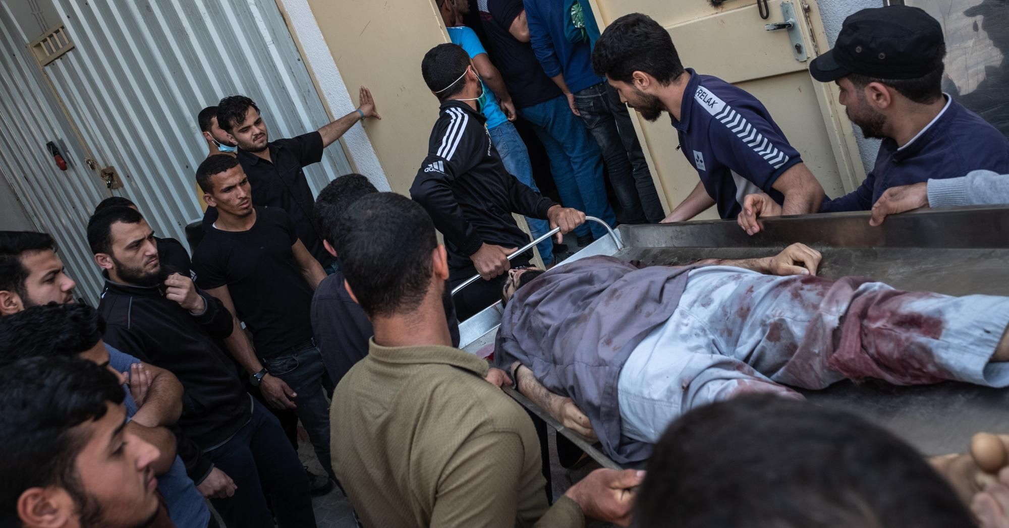 The body of a Palestinian man named Ahmed Al-Shenbari, who was killed during an Israeli raid on Beit Hanoun City, is taken to a mortuary on May 11, 2021 in Gaza. (Photo: Fatima Shbair via Getty Images)
