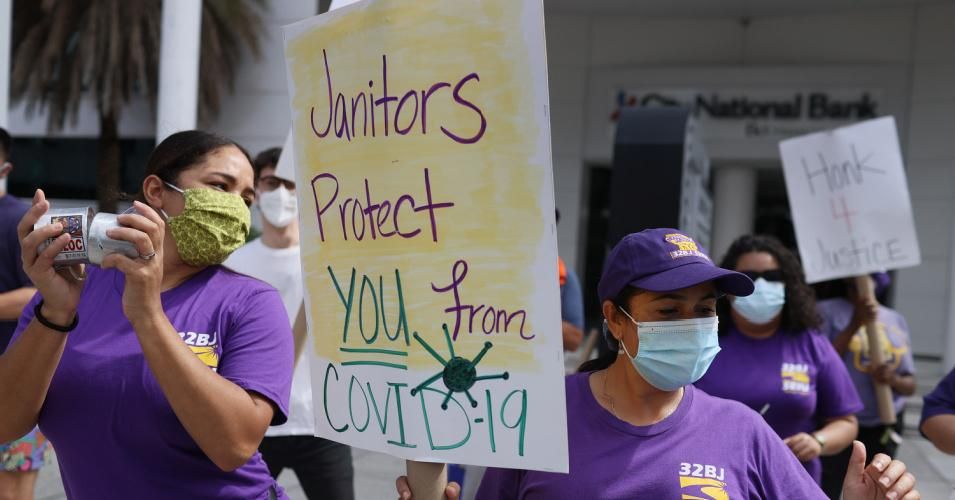 Workers walk a picket line in front of the Miami Tower as they strike against the building's cleaning contractor, SFM Services, on February 12, 2021 in Miami, Florida. They accuse the company of having unsafe working conditions, low wages, intimidation and retaliation over union organizing efforts. (Photo: Joe Raedle/Getty Images)
