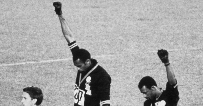 American sprinters Tommie Smith and John Carlos raise their fists and give the Black Power Salute at the 1968 Olympic Games in Mexico City. 