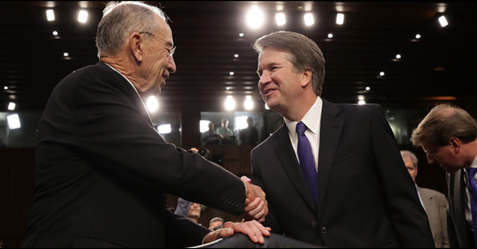 Sen. Chuck Grassley, Republican chair of the Senate Judiciary Committee, shakes hands with Brett Kavanaugh, President Donald Trump's far-right nominee to the U.S. Supreme Court.