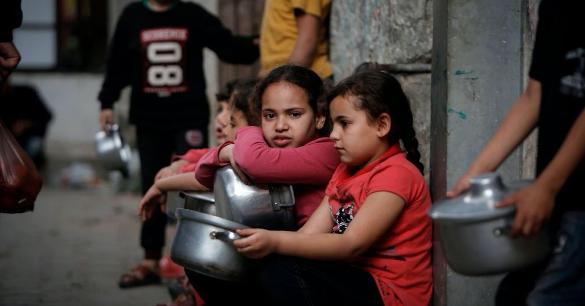Palestinian children are among those waiting in line to receive food aid amid the Covid-19 pandemic in Gaza City, Palestine on April 24, 2020. (Photo: Mohammed Abed/AFP/Getty Images) 