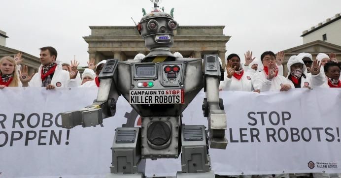 People take part in a demonstration as part of the campaign "Stop Killer Robots" organised by German NGO "Facing Finance" to ban what they call killer robots on March 21, 2019 in front of the Brandenburg Gate in Berlin.