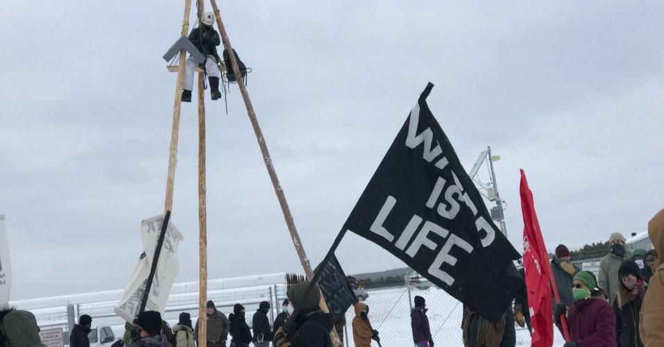 Before climbing a tripod in front of a tar sands pipe yard, Emma Harrison said, "I'm part of the Line 3 resistance movement because this pipeline embodies everything I believe is wrong with the world." (Photo: Honor the Earth/Twitter)