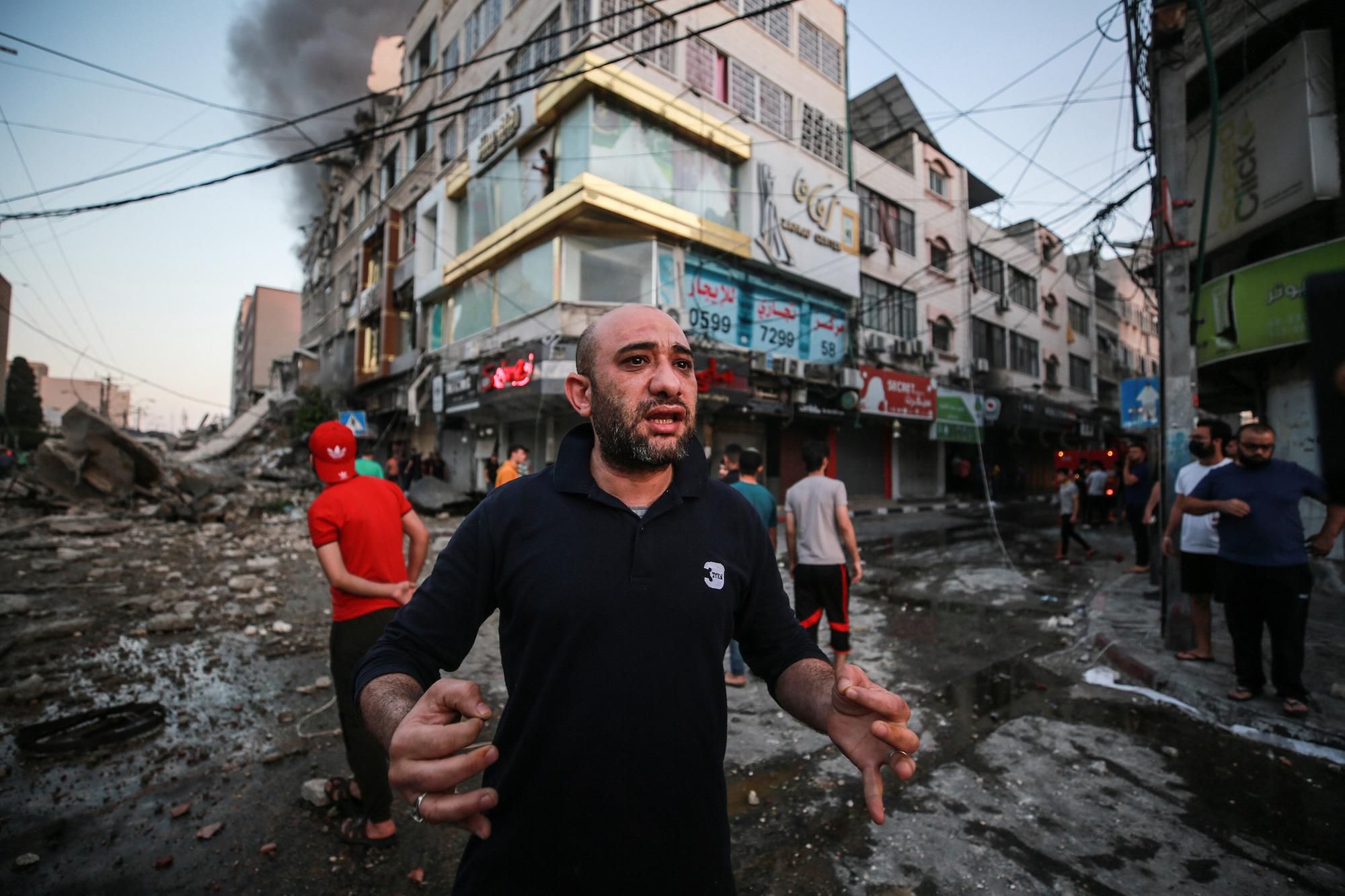 Palestinians inspect the site after Israeli airstrikes hit and collapsed a 14-story Palestinian building called "Ash-Shuruq" at Omar Al-Mukhtar neighbourhood in the Gaza City, Gaza on May 12, 2021. 