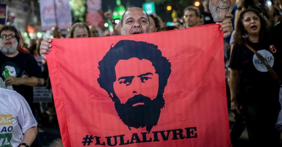 A supporter of the former Brazilian president Luis Inacio Lula da Silva holds a flag during a national strike protest called by unions and students against the Brazilian President Jair Bolsonaro's pension reform in Rio de Janeiro, Brazil, on June 14, 2019. 