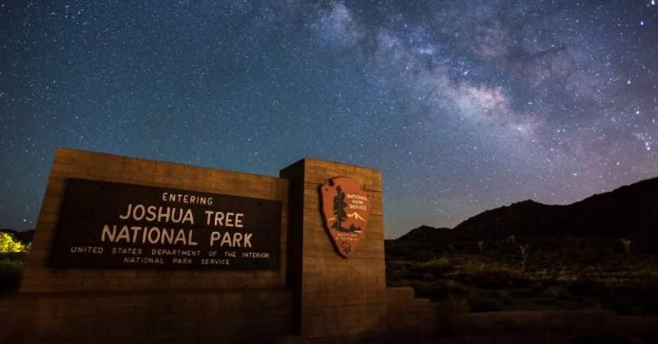 The night sky and entrance sign at Joshua Tree National Park.