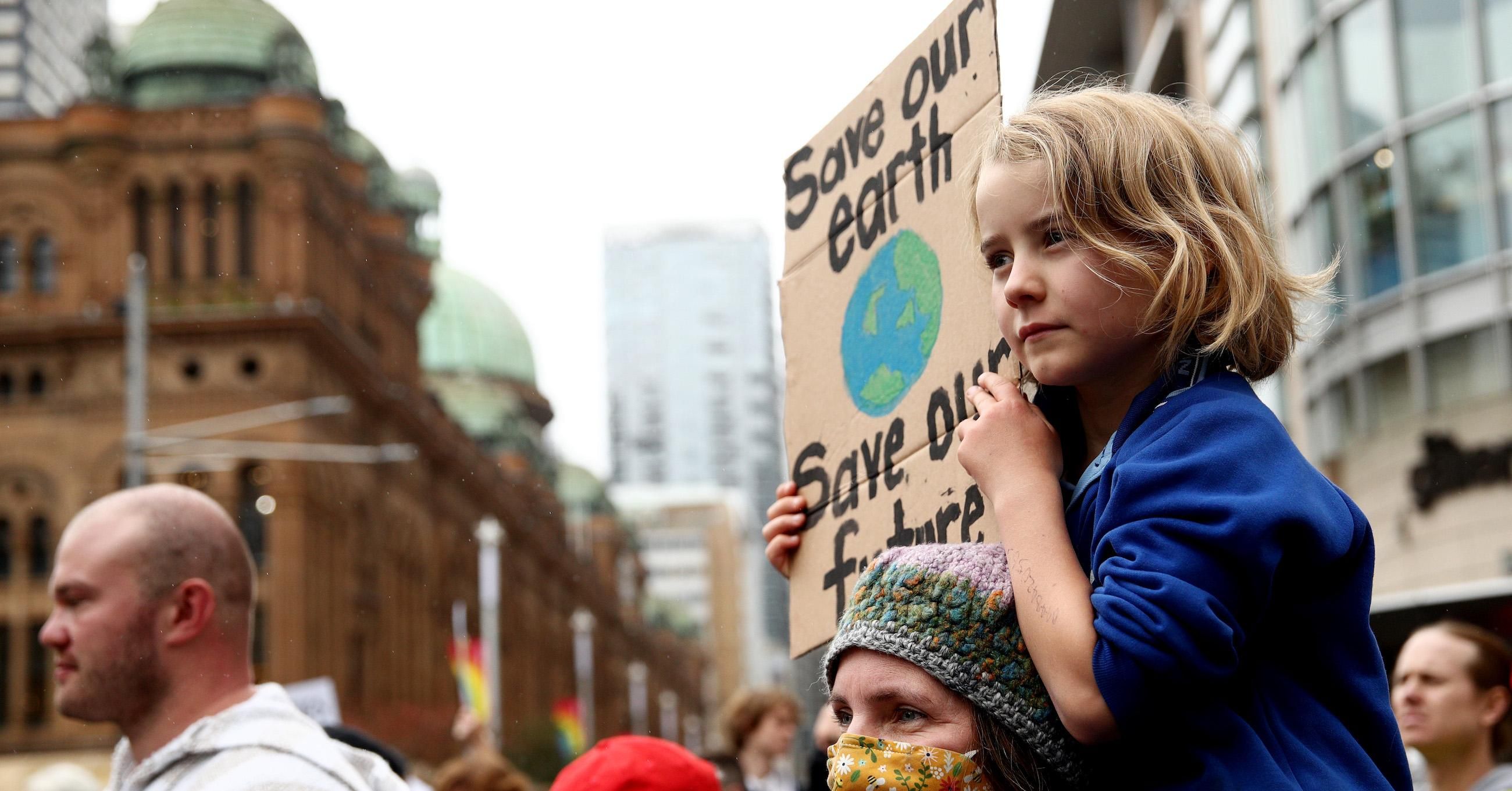 A child holds a sign at Town Hall during the School Strike 4 Climate rally on May 21, 2021 in Sydney, Australia. School Strike 4 Climate rallies are being held across Australia, with students protesting government inaction on the climate emergency. (Photo: Don Arnold/Getty Images)