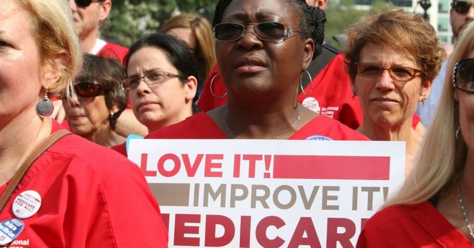 A member of National Nurses United holds a sign at a Bernie Sanders rally that reads: "Love it. Improve it. Medicare for All." (Photo: National Nurses United)