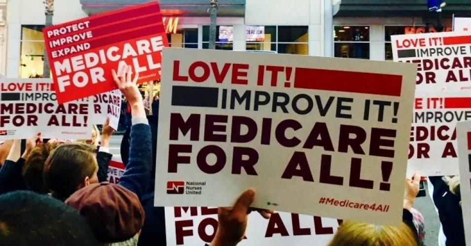 Sign reads: Love it! Improve it! Medicare for All!