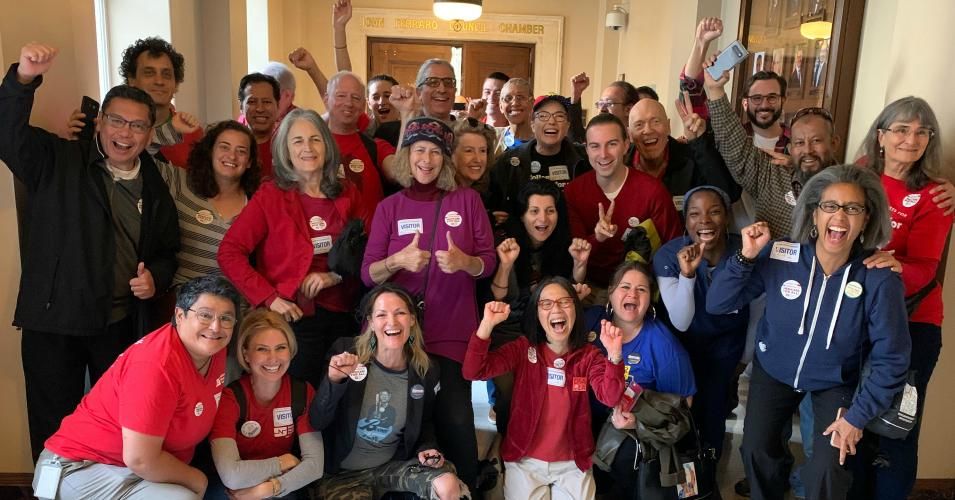 Propopents of the resolution backing Medicare for All celebrate outside the City Council chamber room in Los Angeles after the 10 to 1 vote in favor of passage on Tuesday, November 5, 2019. (Photo: Bonnie Castillo/NNU/CNA)