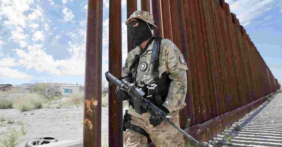 A militia member watches the U.S./Mexico border.