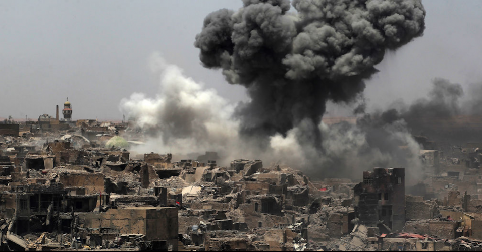 President Donald Trump, who vowed to "bomb the shit out of" Islamic State militants and "take out their families," presided over a dramatic escalation in air and ground attacks on cities including Mosul, Iraq—shown here under U.S. bombardment—in which thousands of civilians were killed. (Photo: Ahmad Al-Rubaye/AFP/Getty Images)