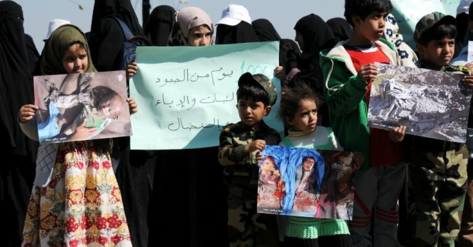 Yemeni children hold pictures of airstrike victims during a rally outside the United Nations Office in Sana'a, Yemen