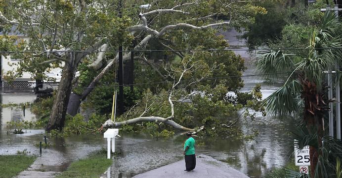 A person looks at a flooded neighborhood as Hurricane Sally passes through the area on September 16, 2020 in Pensacola, Florida. The storm is bringing heavy rain, high winds, and a dangerous storm surge to the area. (Photo: Joe Raedle/Getty Images)