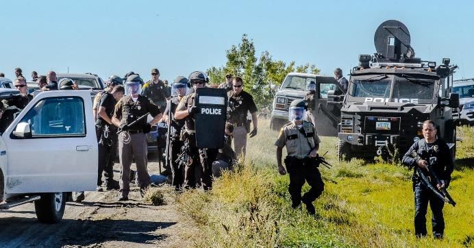 According to photographer Rob Wilson, who documented Wednesday's raid, "roughly 150 peaceful Water Protectors gathered for prayer near construction sites of the Dakota Access Pipeline...and were met with a heavy show of force by authorities." (Photo: Rob Wilson Photography)