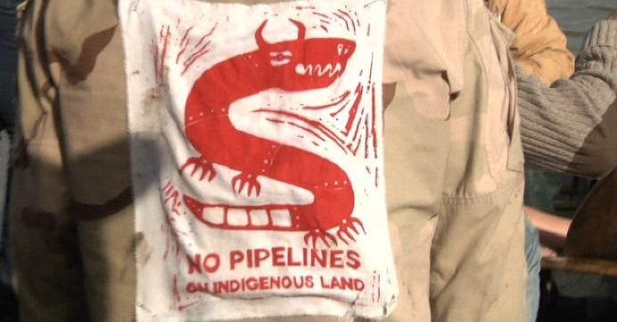 A DAPL protester's shirt says "No Pipelines on Indigenous Lands"