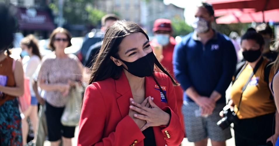 Rep. Alexandria Ocasio-Cortez (D-N.Y.) speaks with a voter near a polling station during the New York primaries on June 23, 2020 in New York City. (Photo: Johannes Eisele/AFP via Getty Images)
