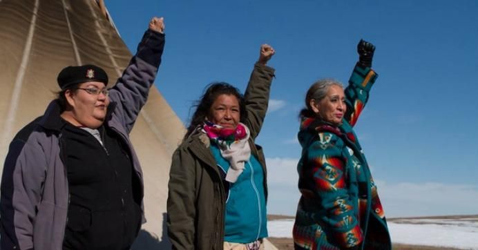 "On this day, and since the beginning, standing for the water: Joye Braun, Tania Aubid, Ladonna Allard," wrote the Indigenous Environmental Network. (Photo: Toni Cervantes via IEN/Twitter)
