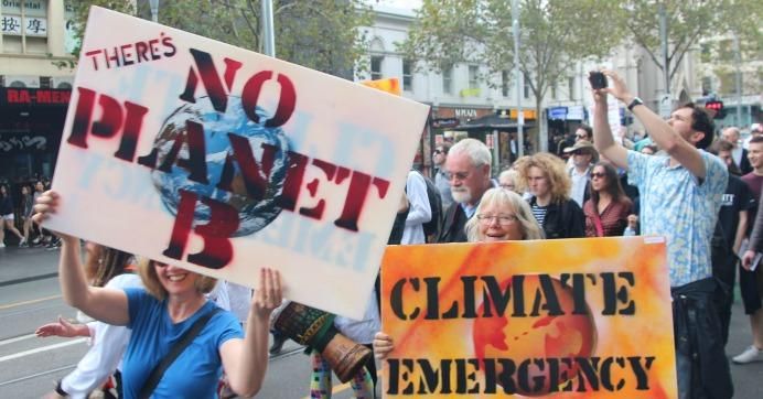Protesters hold signs reading 'No planet B' and 'Climate emergency'