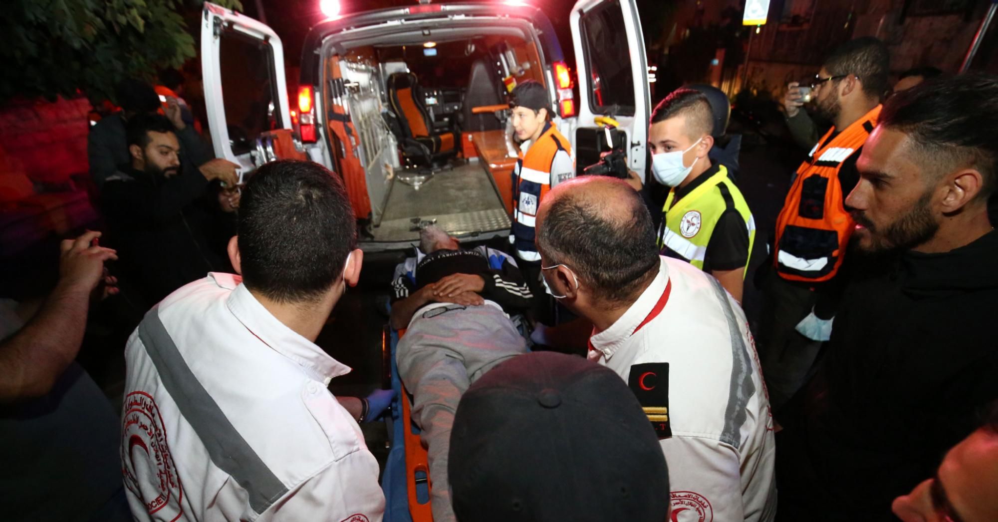 Injured Palestinian Salih Diyab is carried to an ambulance after Israeli forces cracked down on demonstrations against the forced eviction of Palestinian families from their homes in East Jerusalem's Sheikh Jarrah neighborhood on May 6, 2021. (Photo: Mostafa Alkharouf/Anadolu Agency via Getty Images)
