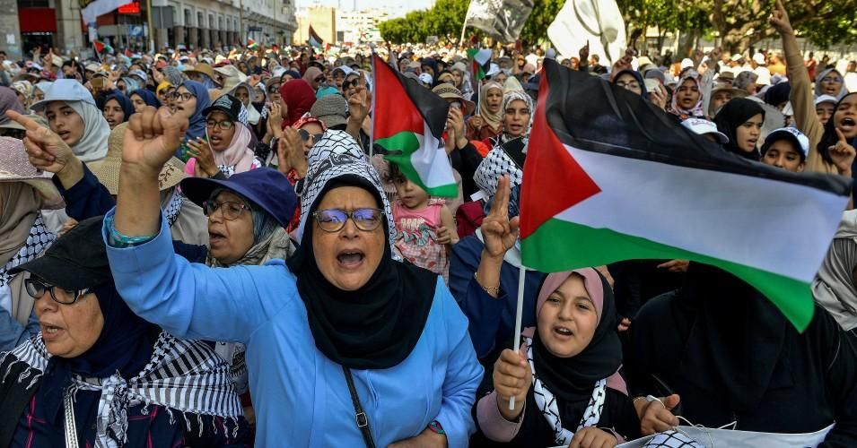 Women chant slogans and gesture as they march with Palestinian flags during a demonstration in the Moroccan capital Rabat on June 23, 2019 against the U.S.-led economic conference in Bahrain with its declared aim of achieving Palestinian prosperity. 