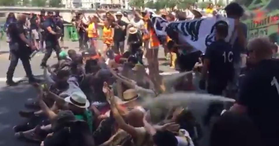 Activists with Extinction Rebellion pepper-sprayed by police as they occupied the Sully Bridge in Paris on Friday. (Photo: Extinction Symbol/Screenshot/via Twitter)