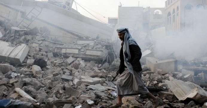 A man walks on rubble of a building destroyed in airstrikes carried out by warplanes of the Saudi-led coalition hours after the UN Special Envoy to Yemen Martin Griffiths departed Sana’a on June 06, 2018 in Sana’a, Yemen.
