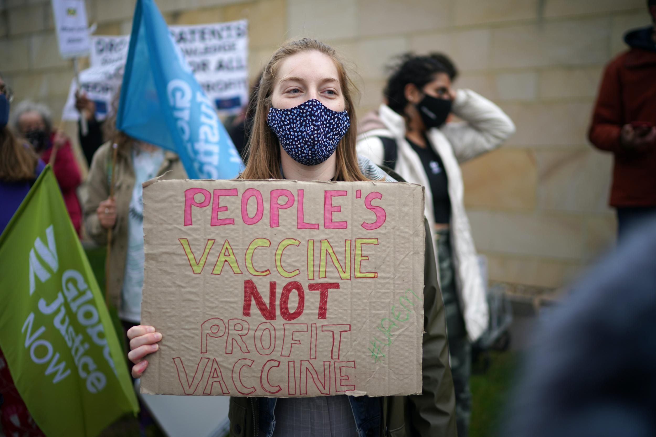 A member of the public health advocacy campaign "The People's Vaccine" protests outside an AstraZeneca site in Macclesfield, United Kingdom on May 11, 2021. The demonstrators called on the pharmaceutical giant to make the technology behind its Covid-19 vaccine free to the world. (Photo: Christopher Furlong/Getty Images) 