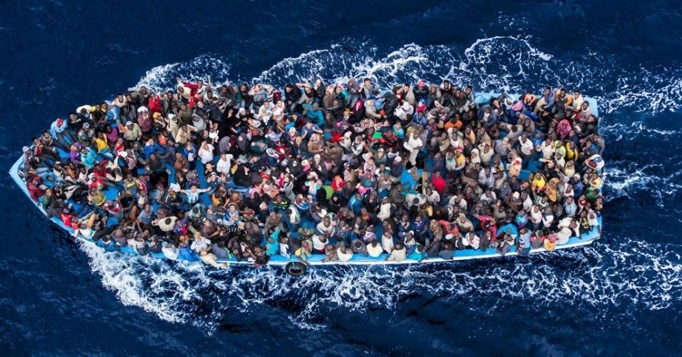 Refugees and migrants on a fishing boat pictured before making contact with the Italian navy. (Photo: Italian Coastguard/Massimo Sestini)