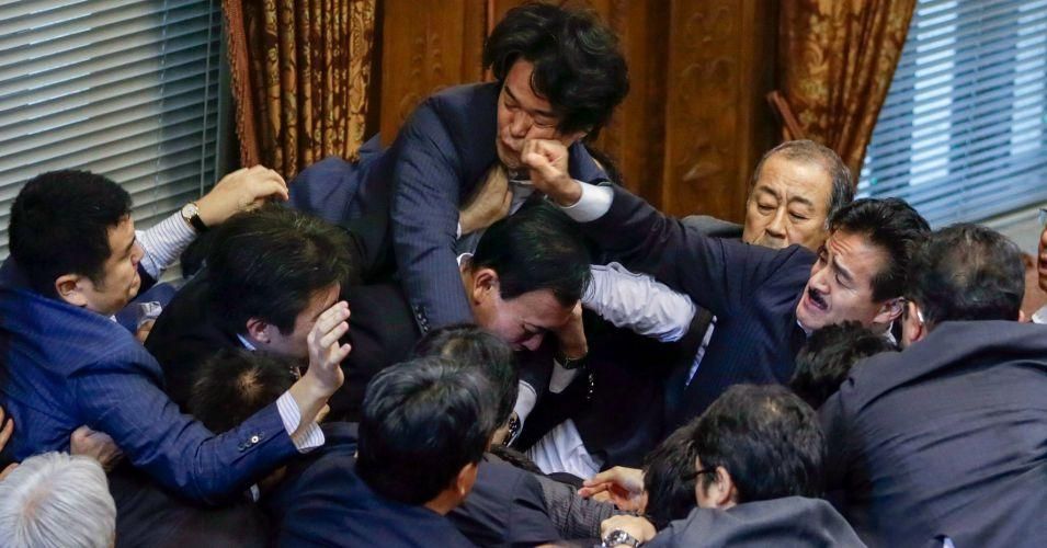 Opposition politician, Yukihiro Knishi, top, punched by ruling party politician, Masahisa Sato in Japan’s Parliament on Thursday. (Photo: Kimimasa Mayama/European Pressphoto Agency)