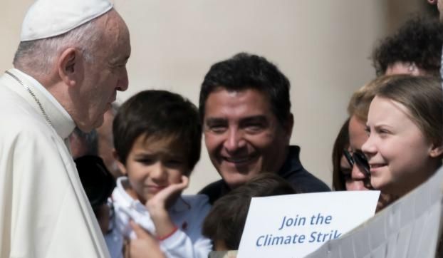 Pope Francis greets Swedish teenage environmental activist Greta Thunberg, right, during his weekly general audience in St. Peter's Square, at the Vatican, Wednesday, April 17, 2019. 