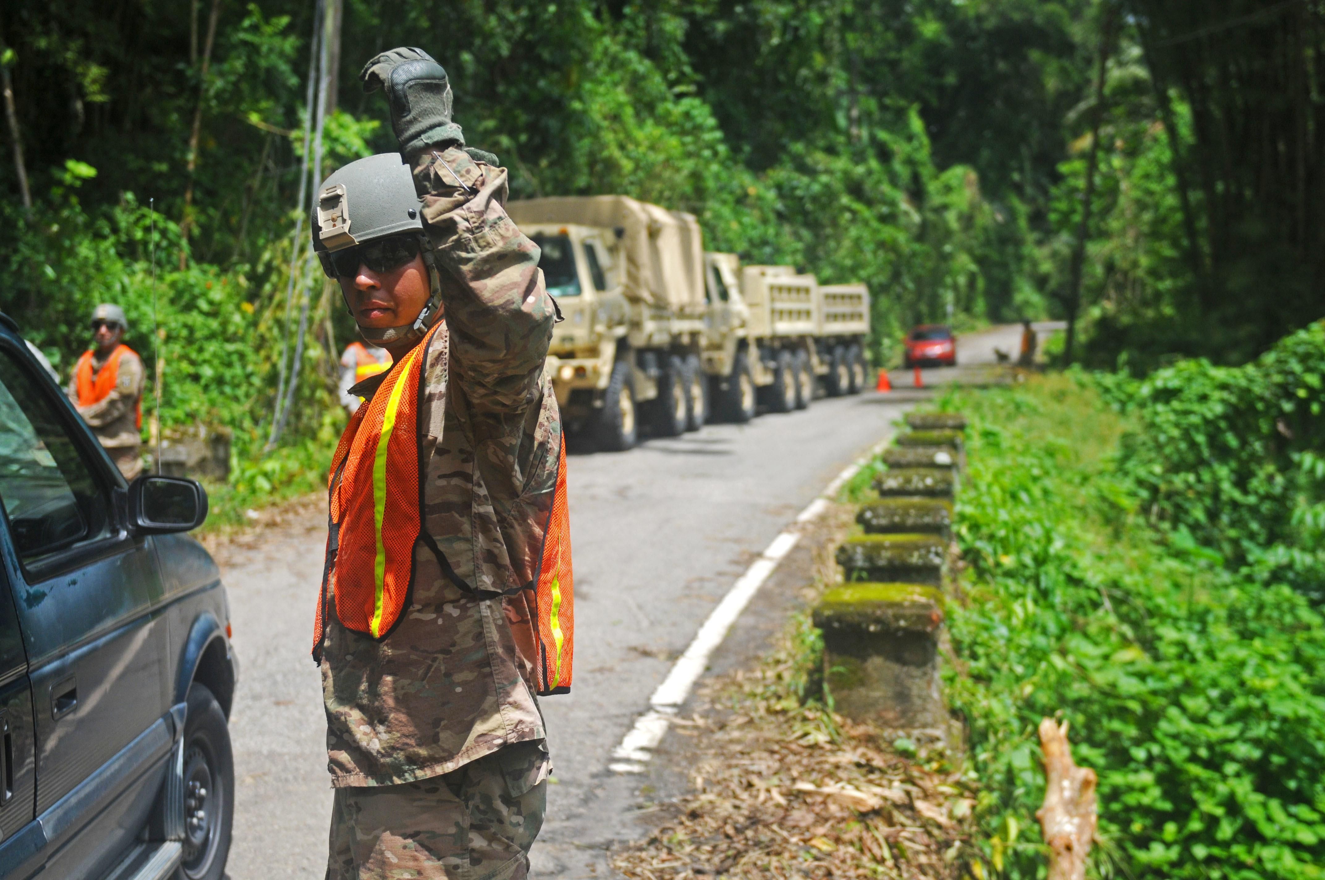 Puerto Rico Army National Guard members work on clearing Highway 511 from Ponce to Jayuya in Puerto Rico, in the aftermath of Hurricane Irma, Sept. 11, 2017. 
