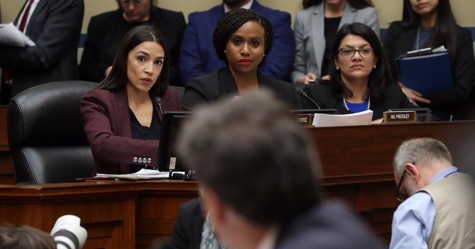 Rep. Alexandria Ocasio-Cortez (D-NY), Rep. Ayanna Pressley (D-MA) and Rep. Rashida Tlaib (D-MI) listen as Michael Cohen, former attorney and fixer for President Donald Trump, testifies before the House Oversight Committee on Capitol Hill February 27, 2019.