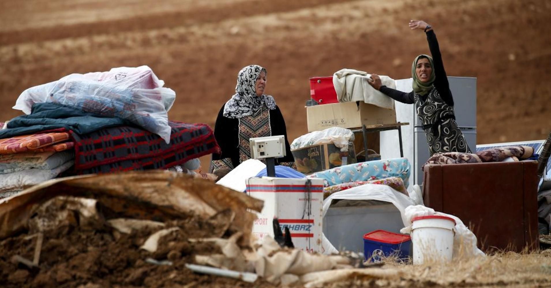 Two women lament the Israeli destruction of their homes and their hamlet of Khirbet Humsa in the illegally occupied Palestinian West Bank on November 3, 2020. (Photo: Jaafar Ashtiyeh/AFP via Getty Images) 