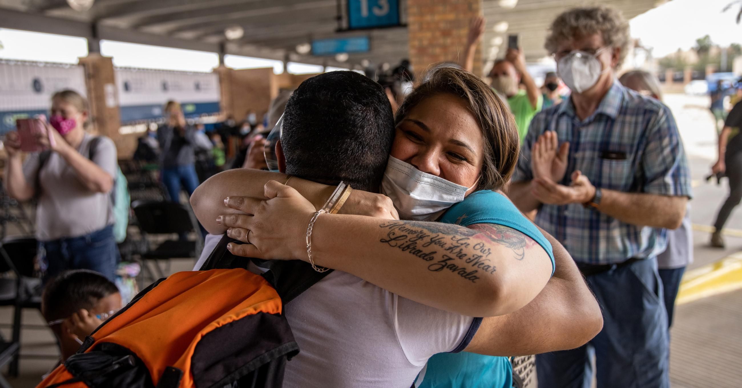 A volunteer welcomes members of a group of 25 asylum-seekers allowed into the United States on February 25, 2021 in Brownsville, Texas. (Photo: John Moore/Getty Images) 