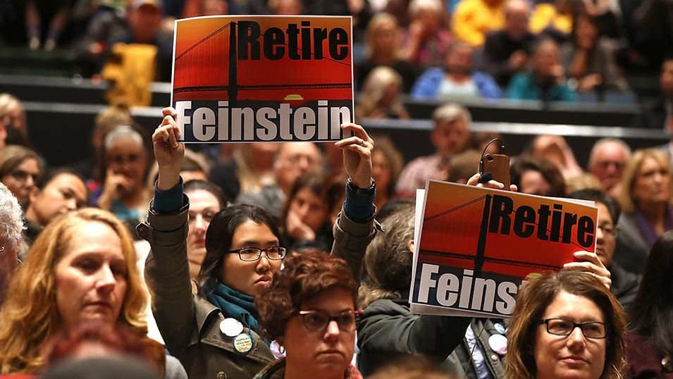 California Democrats shocked Senator Dianne Feinstein by not endorsing her for re-election at their state convention Sunday, February 25, 2018. In photo, attendees hold signs saying 'Retire Feinstein' as U.S. Sen. Dianne Feinstein (D-CA) speaks during a town hall style meeting at the San Francisco Scottish Rite Masonic Center on April 17, 2017 in San Francisco, California. 