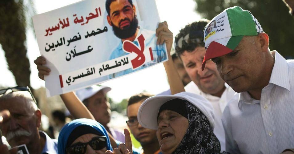 Maazouzeh Allan, mother of hunger-striking Palestinian prisoner Mohammed Allan, protests on Sunday against threats to force-feed her son. (Photo: AMIR COHEN / Reuters)