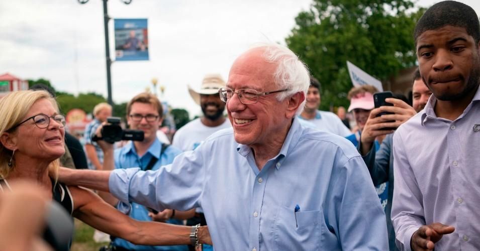 Sen. Bernie Sanders (I-Vt.) greets people as he walks with reporters through the Iowa State Fair in Des Moines, Iowa on August 11, 2019. 